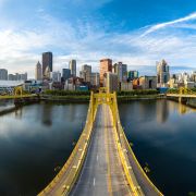 View of the downtown Pittsburgh skyline as viewed across a yellow span bridge, the Warhol Bridge